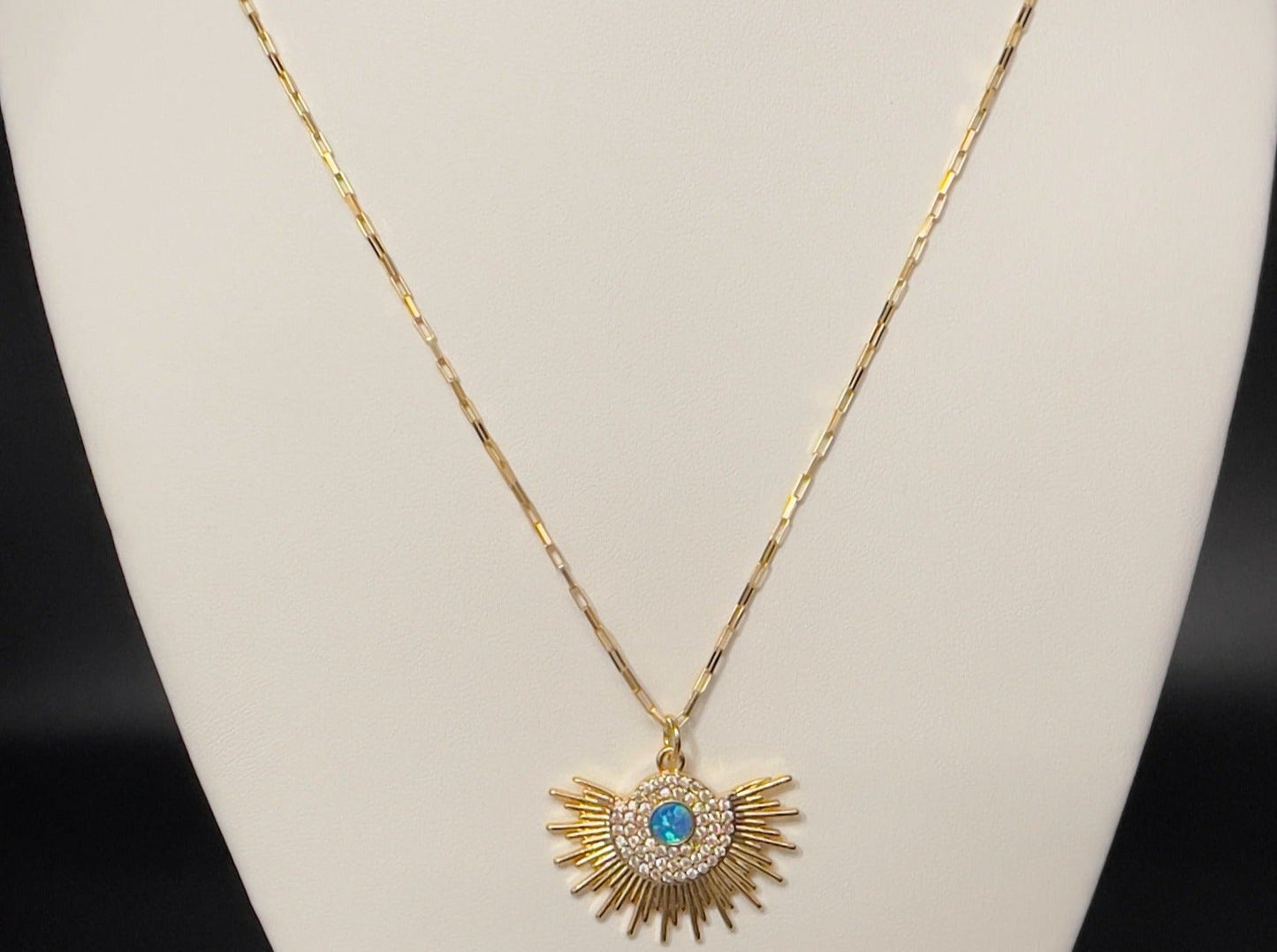 Image of necklace with opal sunburst charm.